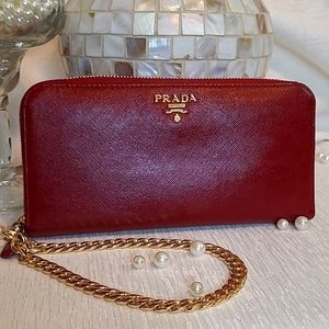 Authentic large Prada red saffiano leather with new gold wrist strap.